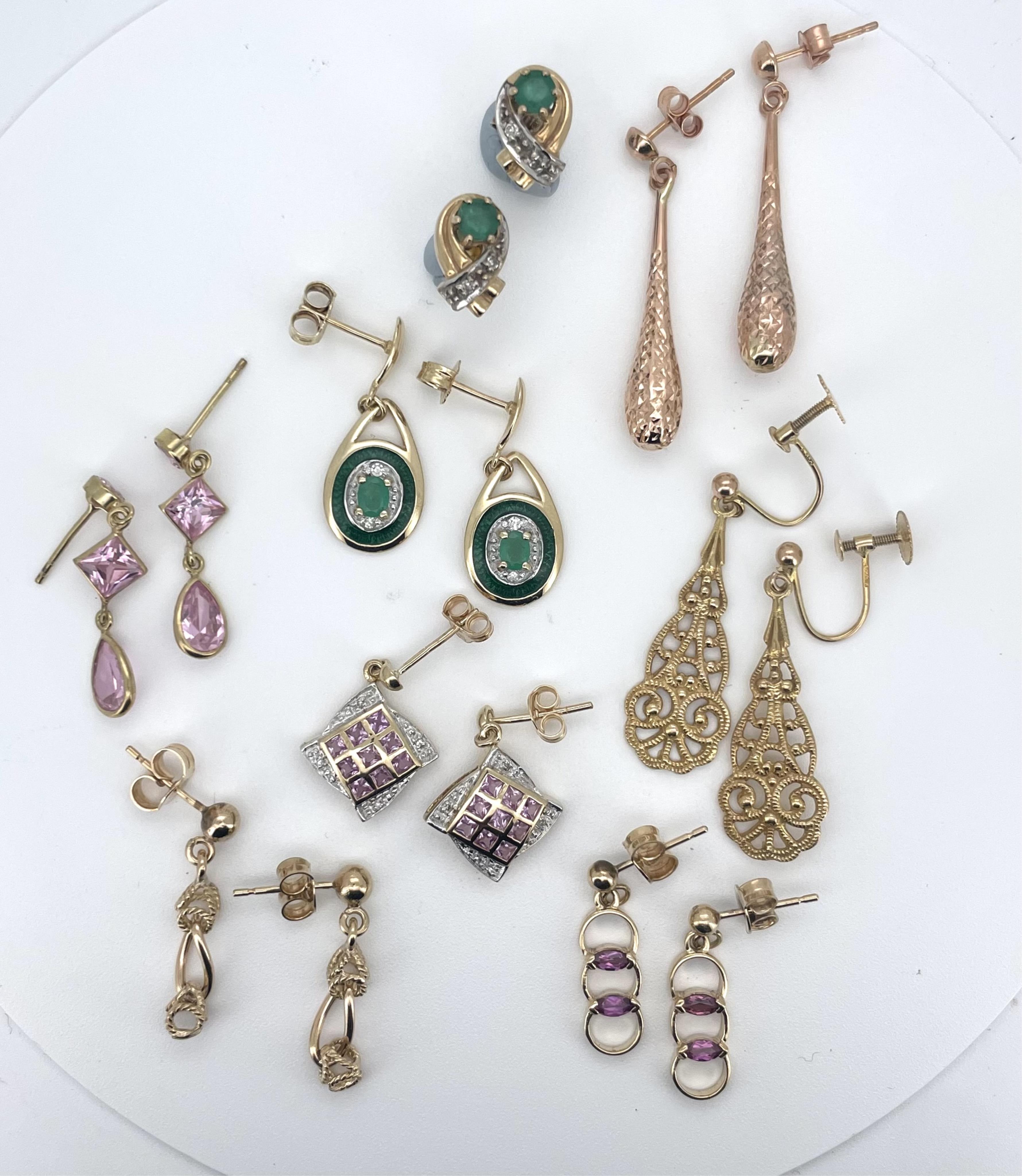 A modern pair of 14k yellow metal, emerald, diamond and enamel set oval drop earrings, 23mm, a similar pair of 10k yellow metal and gem set earrings and six other assorted modern pairs of 9ct/375 earrings including three